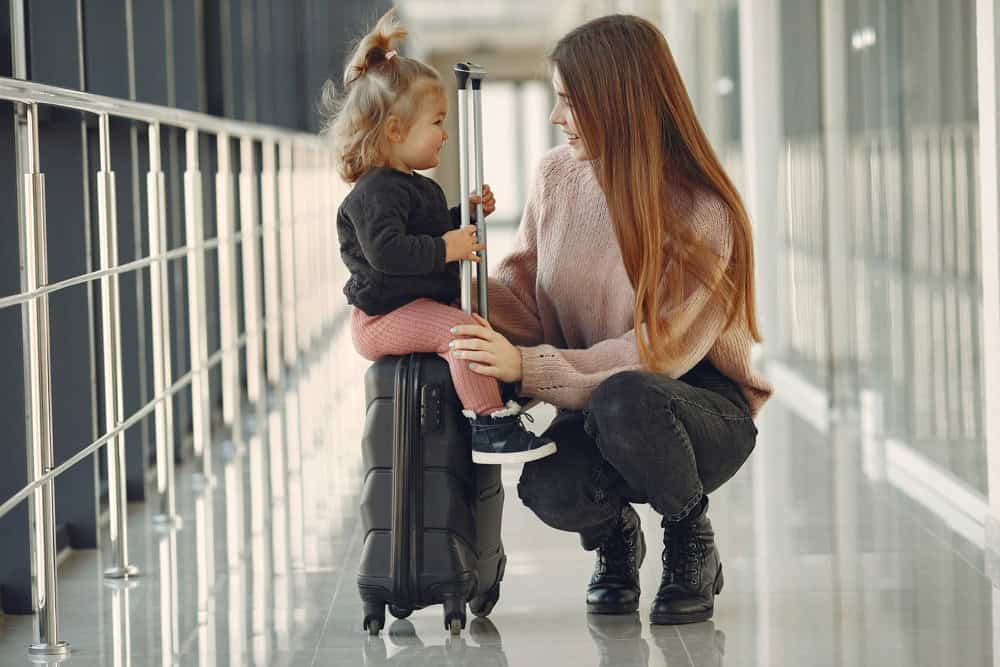Family travelling through an airport with luggage