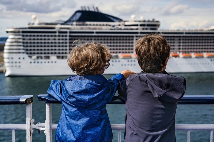 Family with luggage boarding a cruise ship