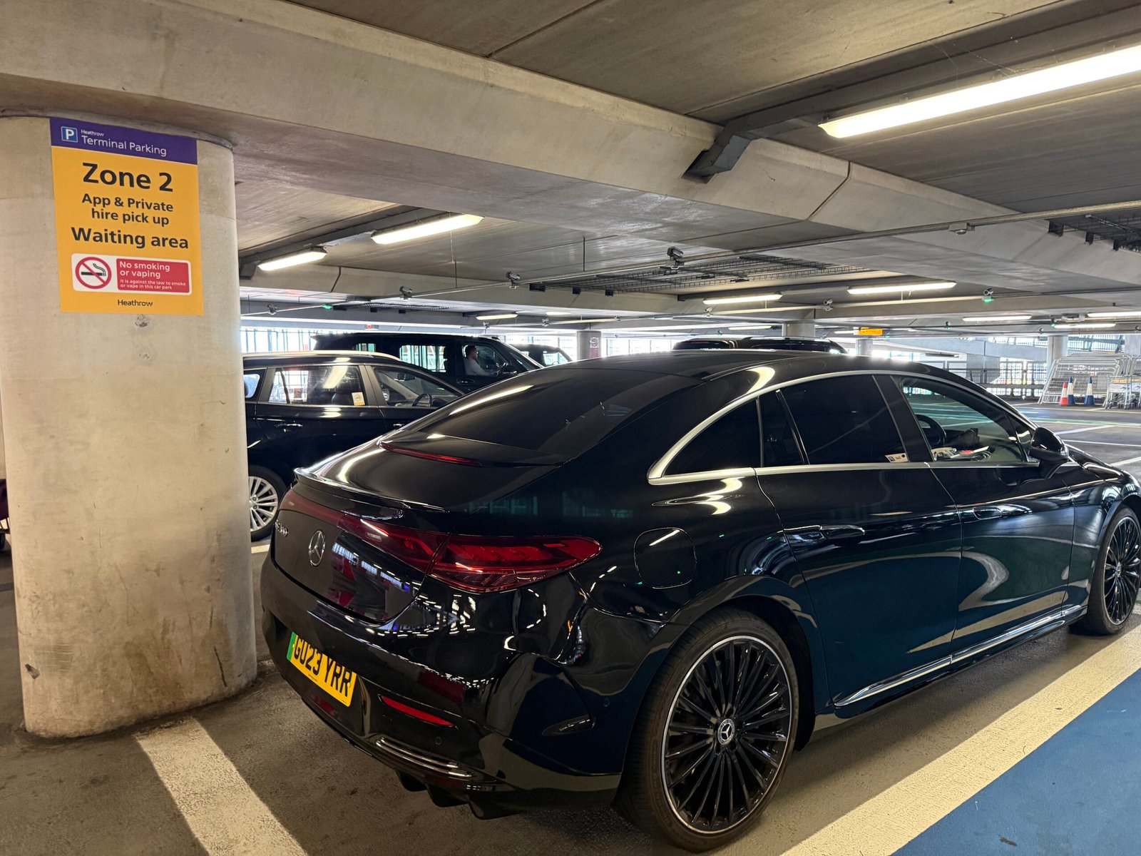 Black Fleet London chauffeur vehicle parked in the Terminal 2 Level 1 collection area