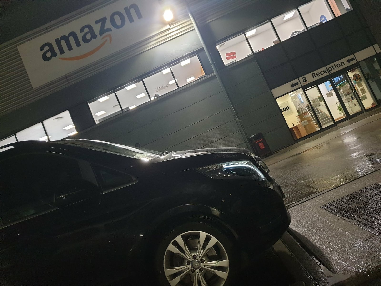Black Performarket MPV working at an Amazon delivery station